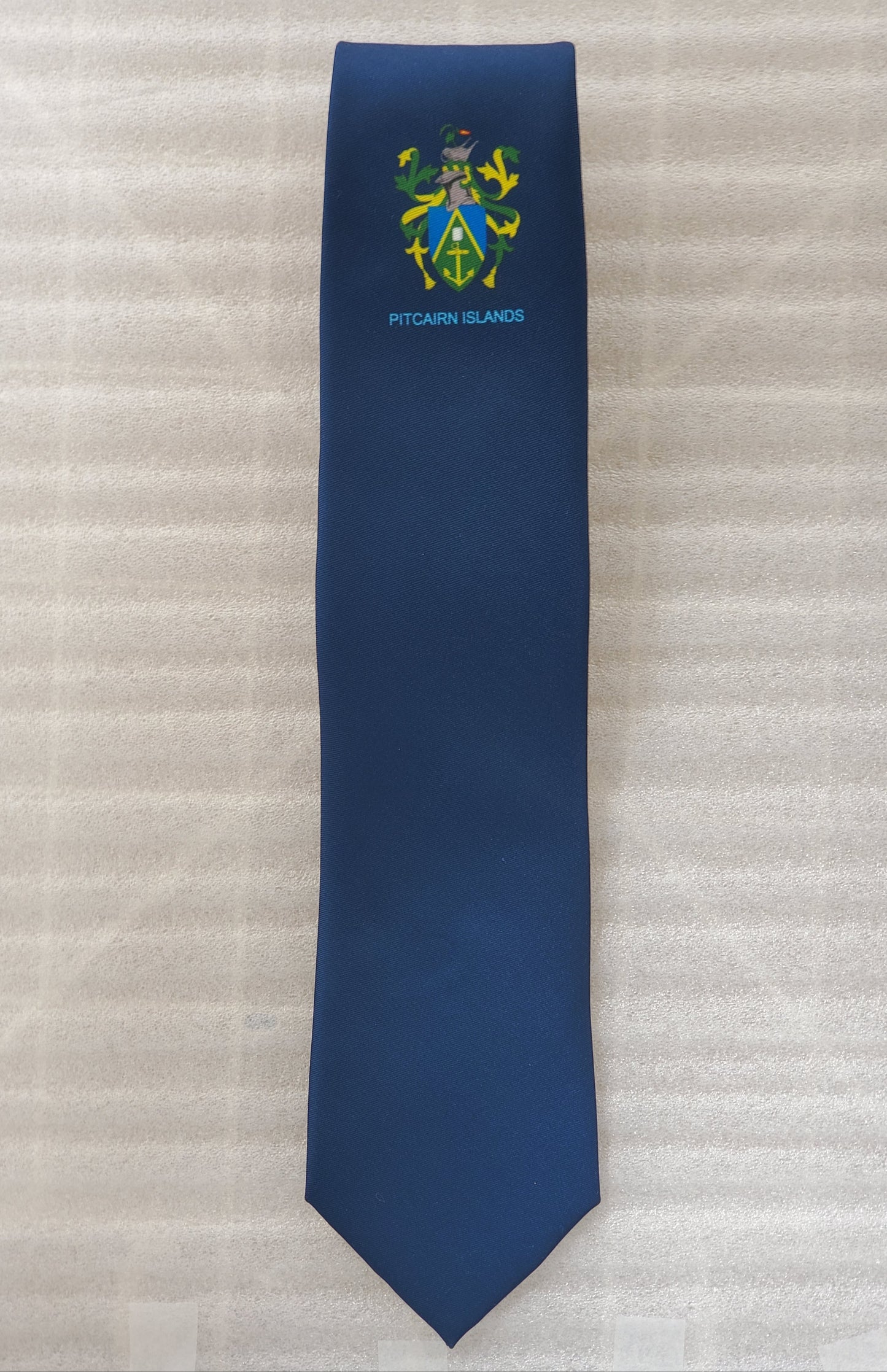Escudo de armas de las Islas Pitcairn - Corbata de marca