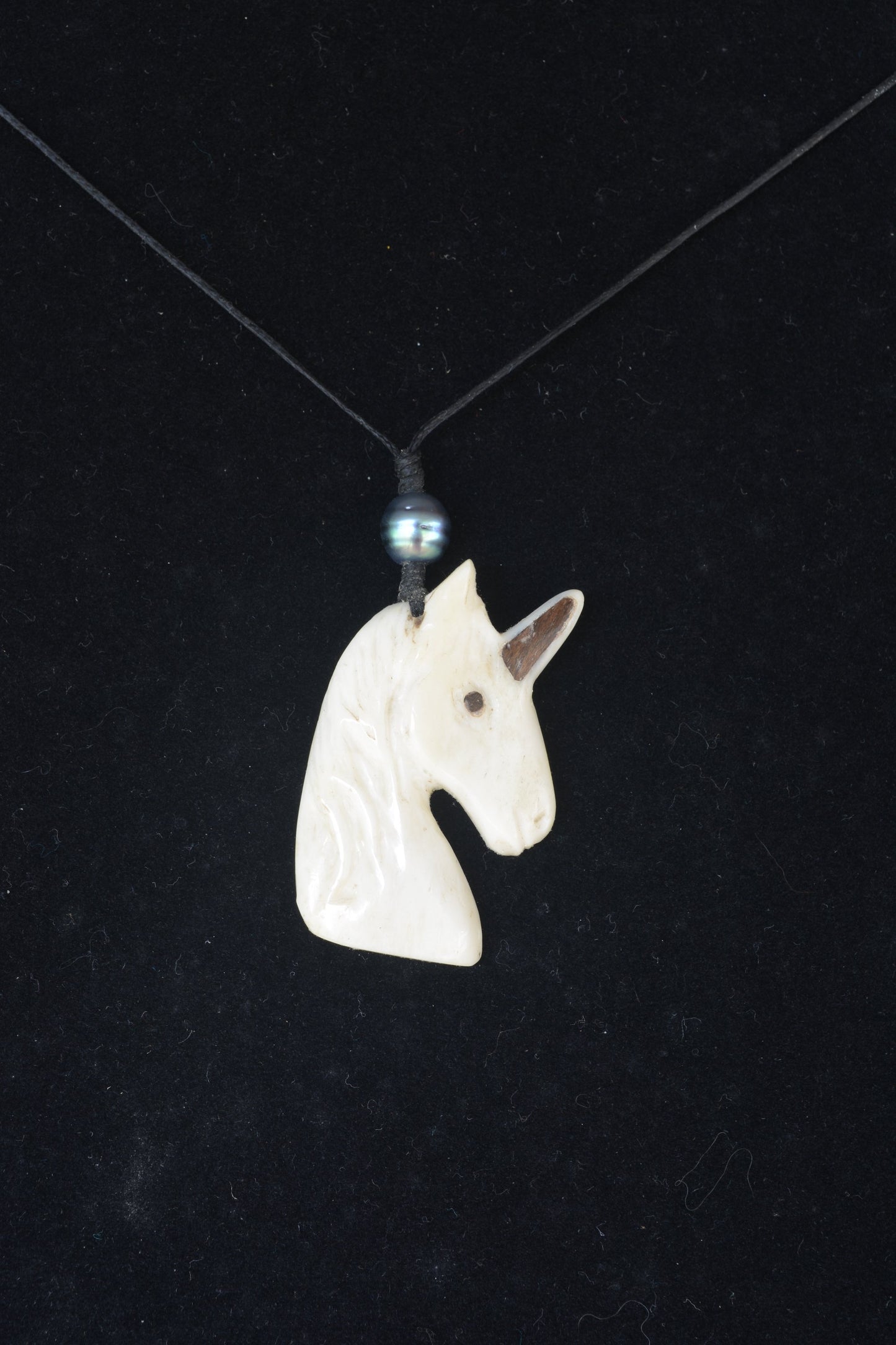 Hand carved bone unicorn necklace